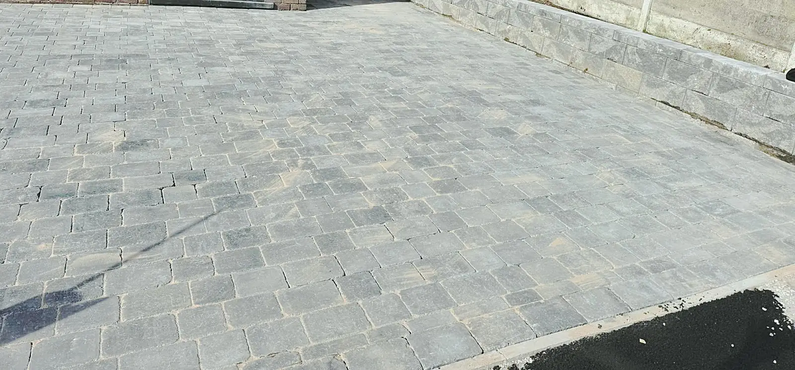 Block paved driveway next to a front door