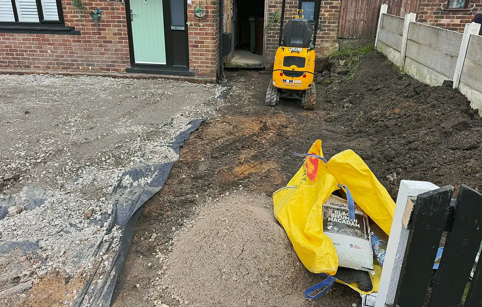 Excavation with a mini digger before a new driveway